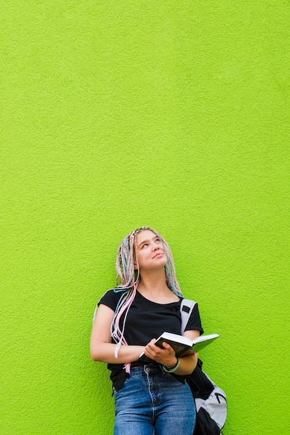 Alegre niña con el libro de texto