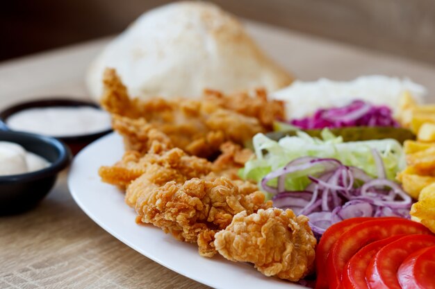 Alitas de pollo frito y verduras