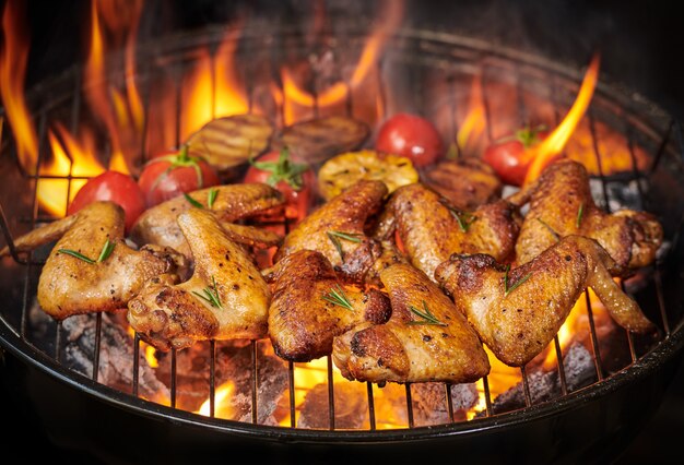 Alitas de pollo a la plancha a la brasa con verduras asadas en salsa barbacoa con pepitas de romero, sal. vista superior con espacio de copia.