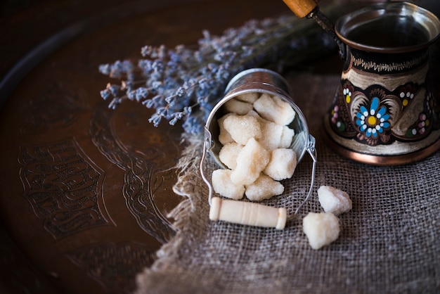 Alta vista del cubo lleno de terrones de azúcar y café