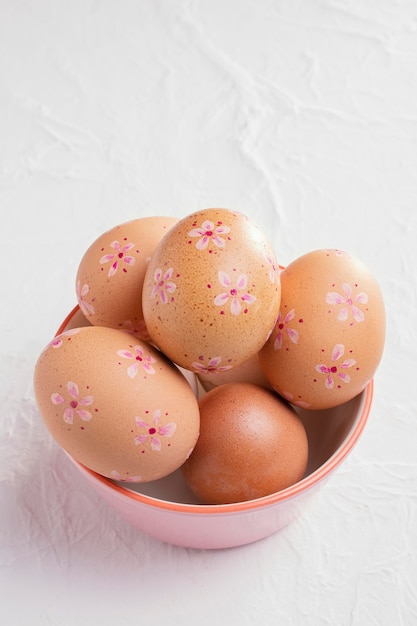 Alto ángulo de huevos de Pascua decorados en un tazón