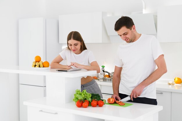 Alto ángulo joven pareja preparando ensalada