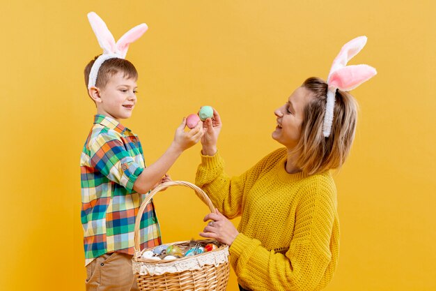 Alto ángulo madre e hijo con huevos pintados