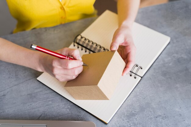 Alto ángulo de mujer escribiendo en caja