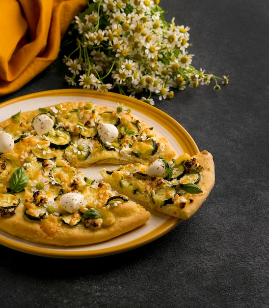 Foto gratuita alto ángulo de plato de pizza con flores.