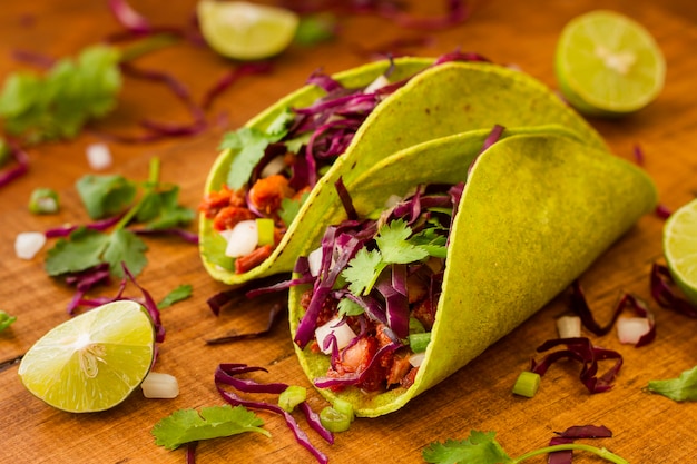 Foto gratuita alto ángulo sabroso tacos en mesa de madera