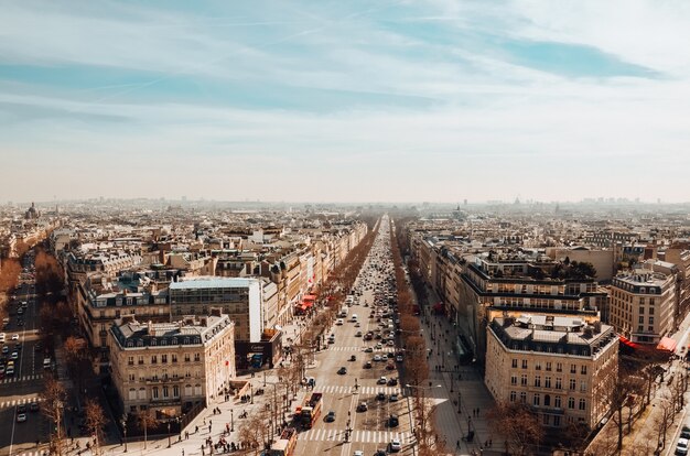 Un alto ángulo de vista de la Avenue des Champs-Elysees bajo un cielo nublado y la luz del sol en París