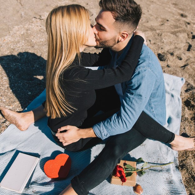 Amante joven pareja besándose apasionadamente en la playa