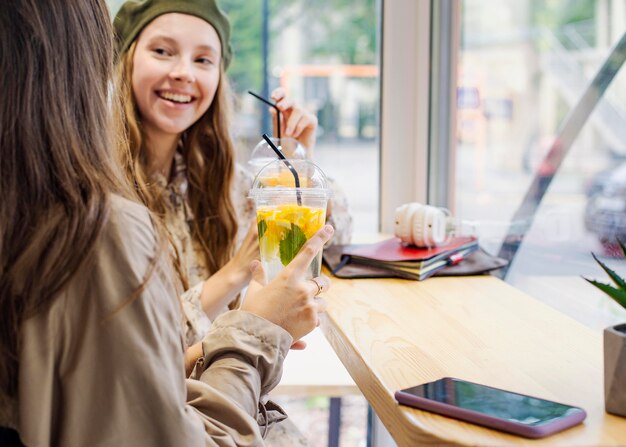 Amigos con bebidas frescas en la cafetería