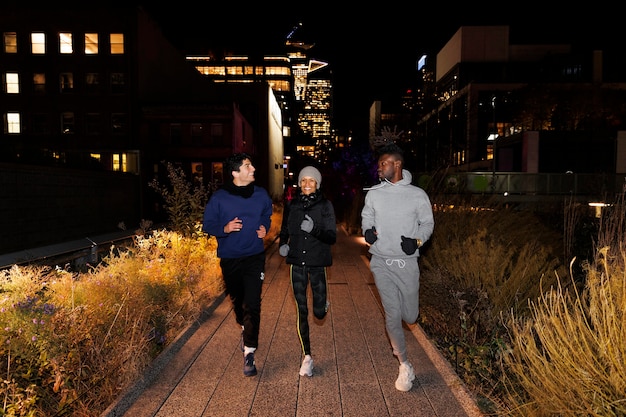 Amigos corriendo de noche en la ciudad.