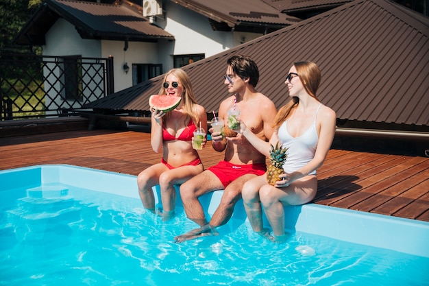 Amigos disfrutando de sus vacaciones en la piscina.