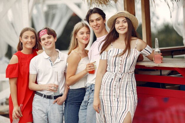 Amigos divirtiéndose en una playa con bebidas