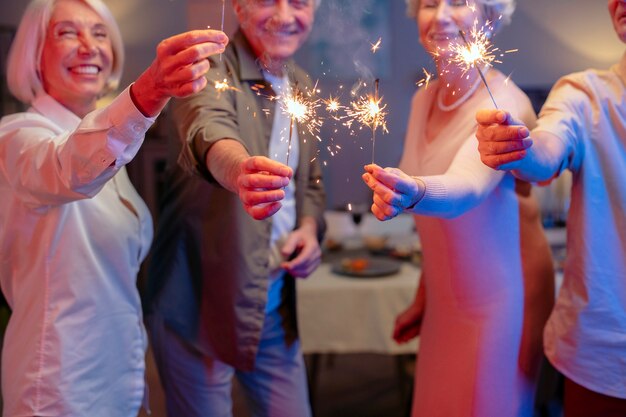 Amigos mayores que tienen una fiesta por la noche