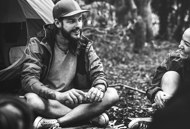 Amigos que acampan en el bosque juntos