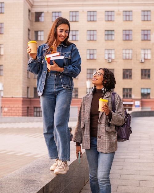 Amigos sonrientes con café y libros