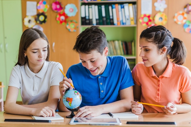 Amigos sonrientes estudiando en el colegio