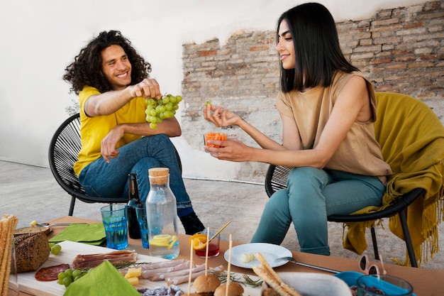 Amigos de tiro completo comiendo uvas