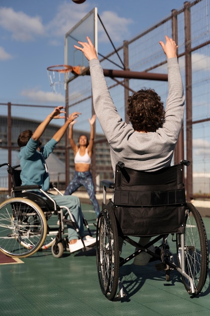 Foto gratuita amigos de tiro completo jugando baloncesto