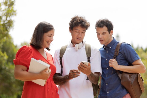 Amigos de tiro medio con teléfono