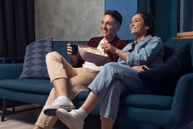 Amigos viendo servicio de streaming juntos en interiores