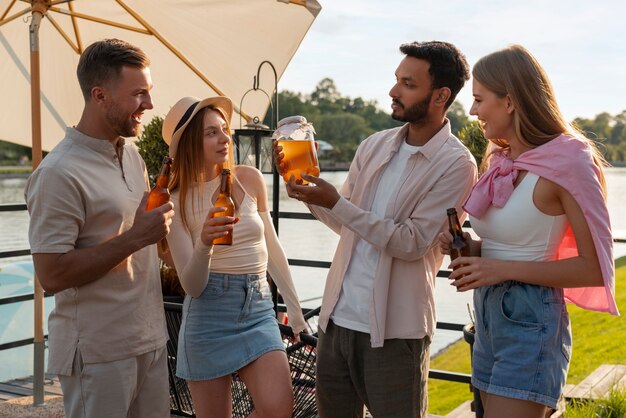 Foto gratuita amigos de vista frontal con deliciosa kombucha al aire libre