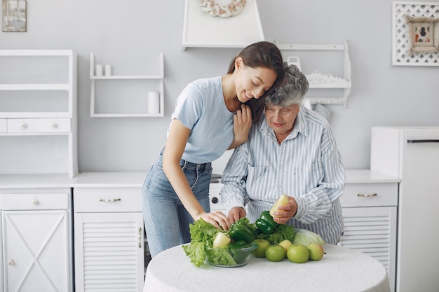 Anciana en una cocina con nieta joven