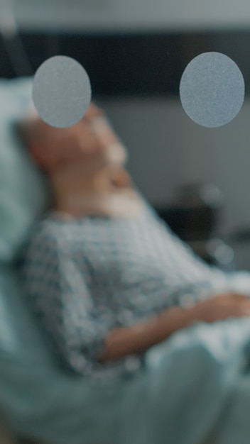 Foto gratuita anciano enfermo tendido en la cama de la sala de hospital con collarín cervical