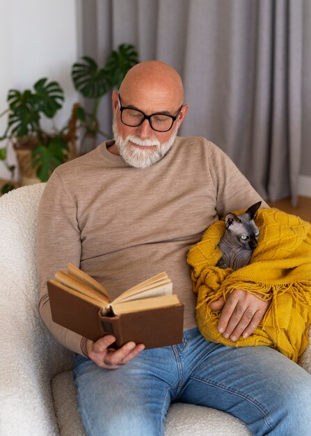 Foto gratuita anciano con gato mascota