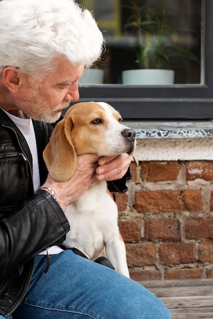 Foto gratuita anciano con su perro mascota