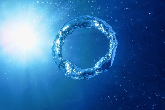 El anillo de burbujas asciende hacia el sol, bajo el agua