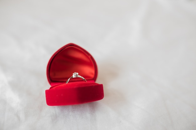 Anillos de boda en una caja sobre la cama.