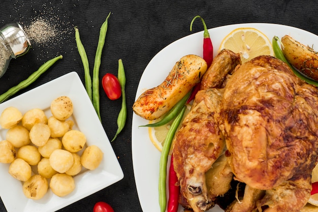 Apetitoso pollo entero a la plancha con diversas verduras.