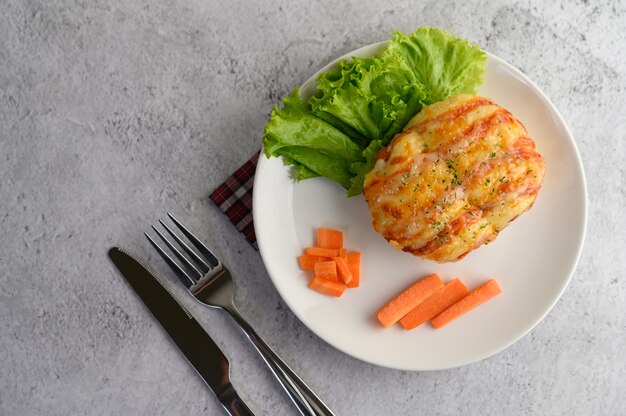 Apetitoso rollo de pan de salchicha en un plato blanco