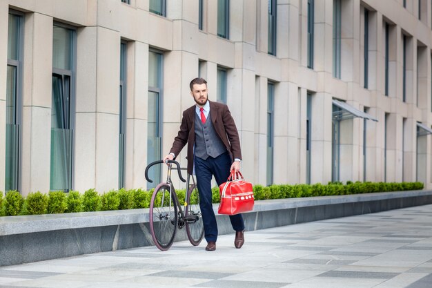 Apuesto hombre de negocios y su bicicleta