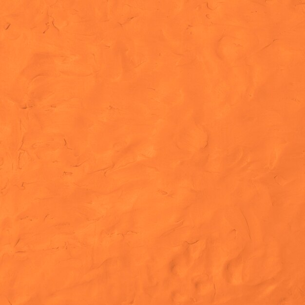 Foto gratuita arcilla naranja con textura de fondo colorido arte creativo hecho a mano estilo abstracto