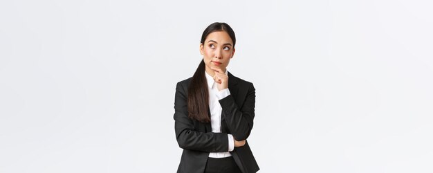 Arquitecta profesional inteligente mujer industrial en traje pensando en una solución mirando hacia arriba l