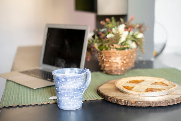 Arreglo de ángulo alto con laptop y taza