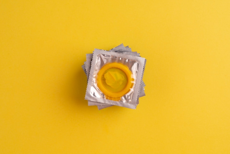 Foto gratuito arreglo de condones amarillos de vista superior