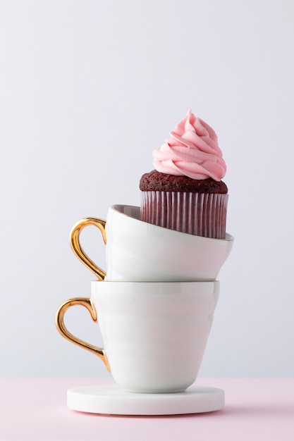 Arreglo delicioso cupcake y tazas