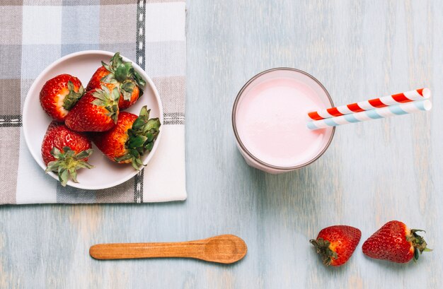 Arreglo de fresas y batido con pajitas.