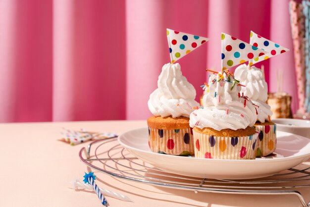 Arreglo de mesa para evento de cumpleaños con cupcakes y banderas