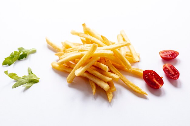 Arreglo con papas fritas y tomates sobre fondo blanco.