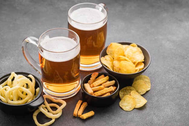 Arreglo de patatas fritas y jarras de cerveza