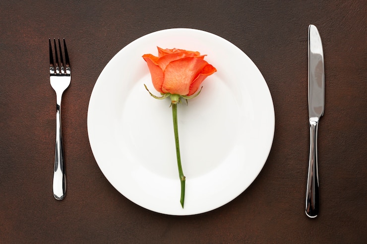 Foto gratuito arreglo plano para la cena de san valentín con rosa naranja