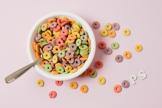 Foto gratuita arreglo de vista superior con tazón de cereal sobre fondo rosa