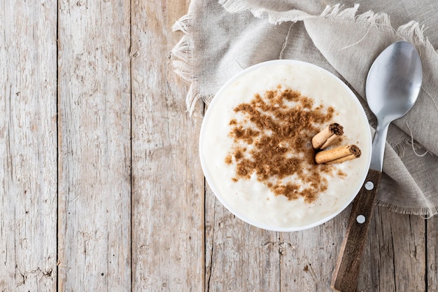 Foto gratuita arroz con leche arroz con leche con canela en un tazón sobre mesa de madera