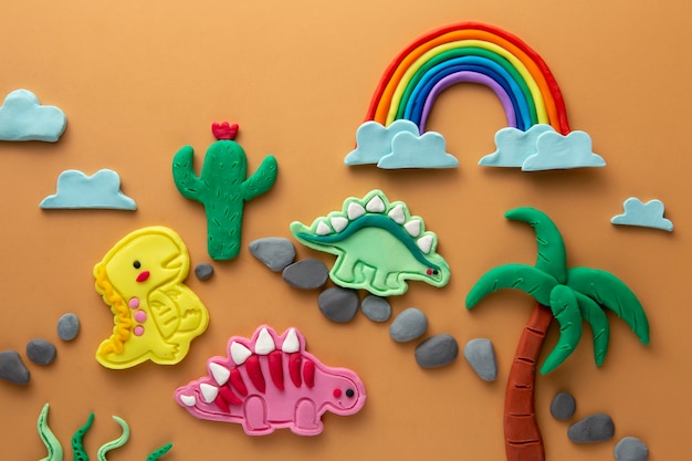 Foto gratuita arte de plastilina con dinosaurios y arcoíris.