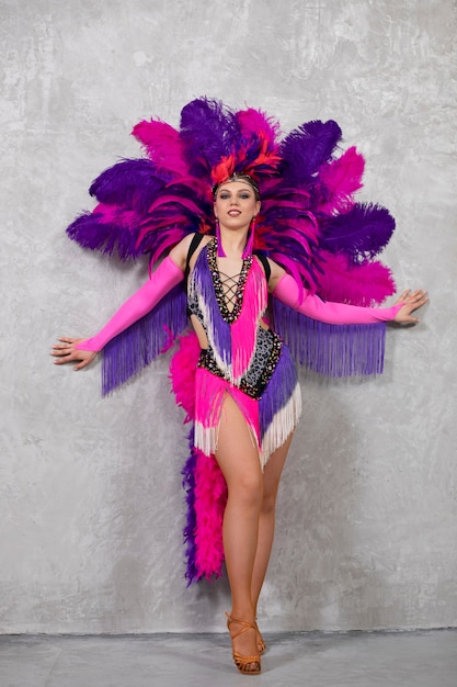 Artista de cabaret femenino posando en traje de plumas