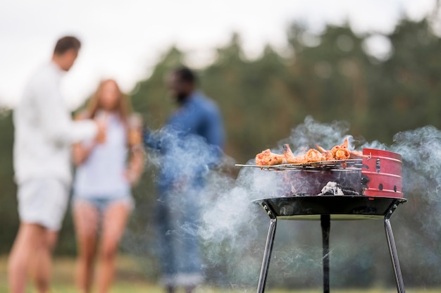 Foto gratuita asar comida a la barbacoa con amigos conversando