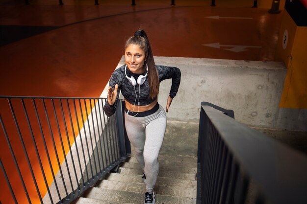 Atleta femenina atractiva corriendo y entrenando